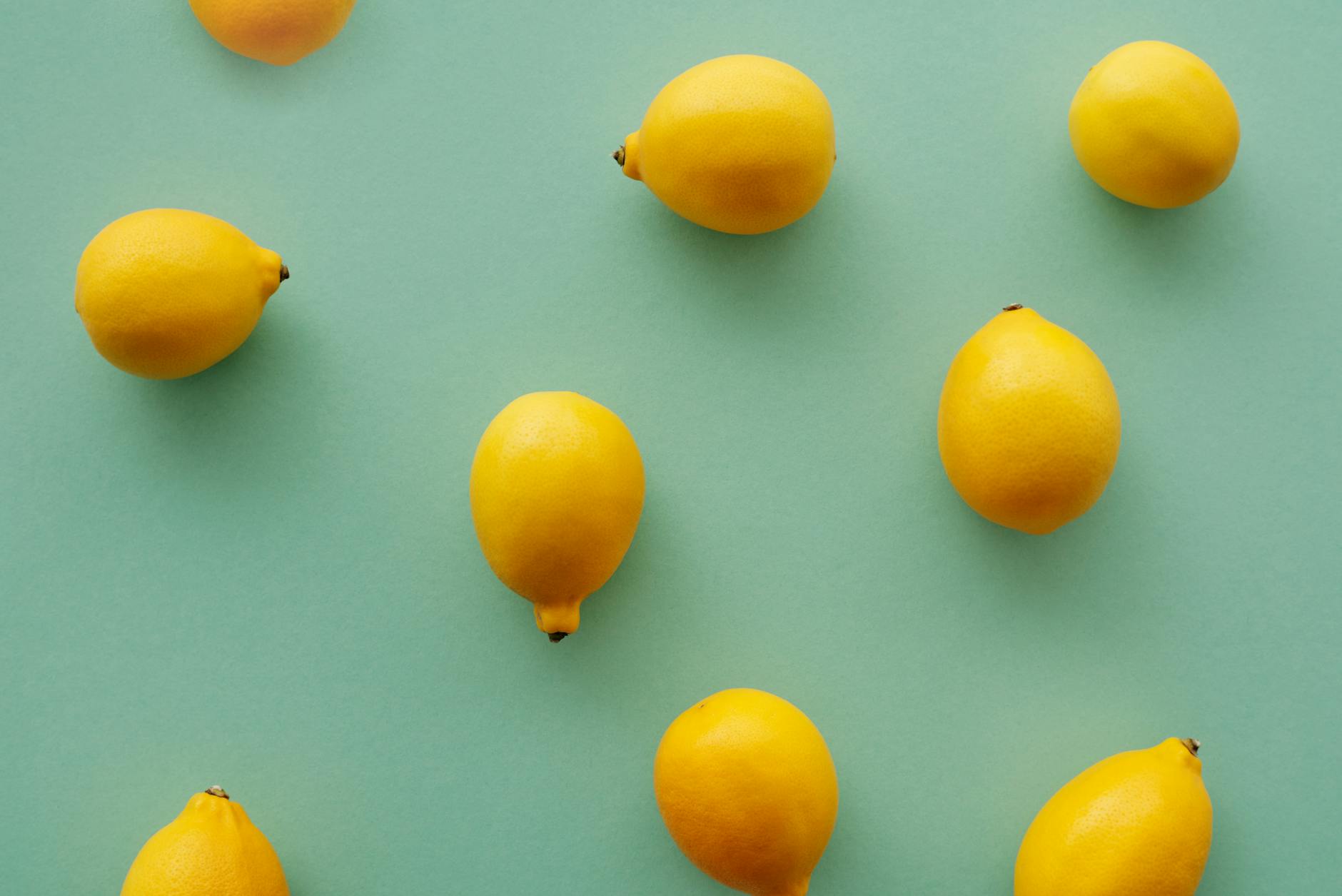 Bright yellow lemons on a pastel background, symbolizing fresh starts and renewed pleasure.
